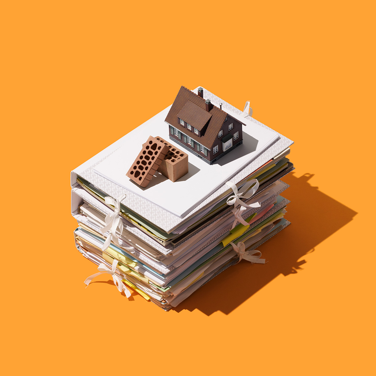 Conceptual home on a stack of papers